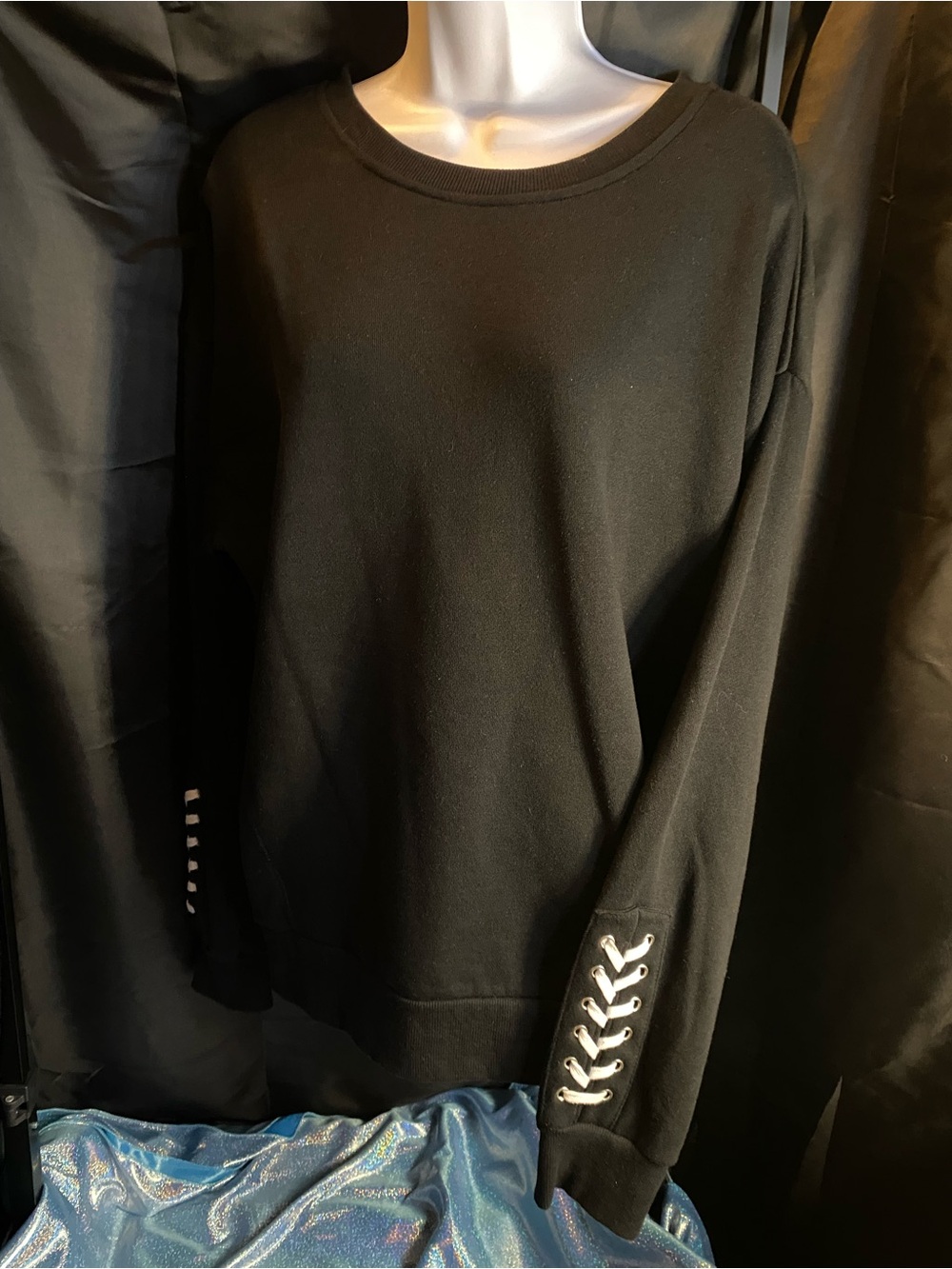 Black ultra-soft fleece crewneck-distinctive white lace-up detailing on cuffs